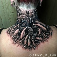 the back of a woman's neck with an octopus tattoo