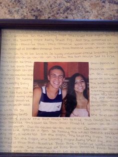 two people are smiling and posing in front of an old paper with writing on it