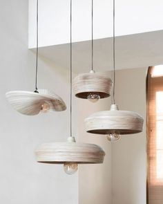 three lamps hanging from the ceiling in a room