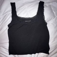 Perfect Condition, Never Worn. Super Soft And Light. Slightly Cropped. Black Lace Trim Including The Straps. Ask Any Questions! 97% Viscose, 3% Elastane Black Sleeveless Crop Top With Lace Trim, Fitted Black Tank Top With Lace Trim, Casual Black Tank Top With Lace Trim, Casual Black Lace Trim Tank Top, Lace Trim Tank Top, Black Lace Trim, Black Lace, Lace Trim, Rib Knit