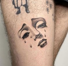 a close up of a person's leg with a tattoo on it and the face of a woman