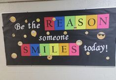 a bulletin board that says be the reason someone smiles today with smiley faces on it