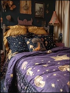 a bed with purple and gold comforters in a room filled with pictures on the wall