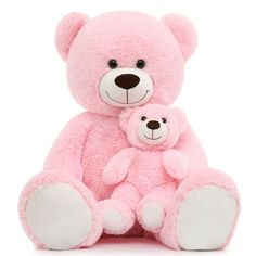 a pink teddy bear and its baby sitting next to each other