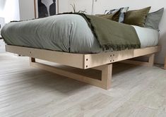 a bed sitting on top of a wooden platform