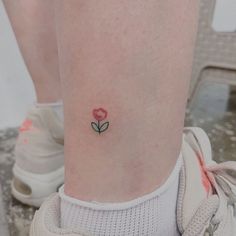 a small rose tattoo on the ankle