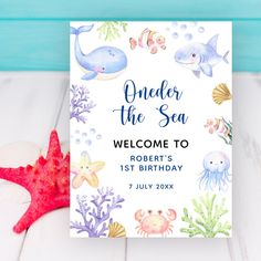 an under the sea welcome card with starfish, corals and other marine creatures