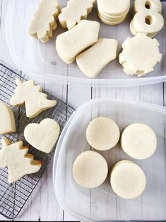 two plastic trays filled with cut out cookies