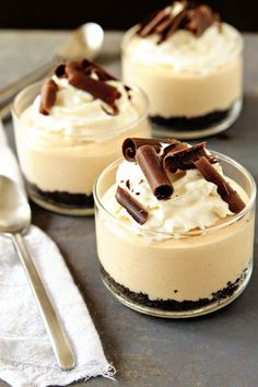 three desserts in small glass dishes on a table