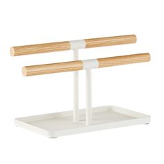 two wooden sticks are on a white stand