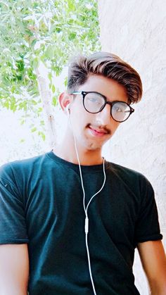 a young man wearing glasses and headphones