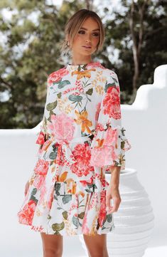 Vibrant oversized blooms bring the garden to the party in this belted dress made for sashaying with its ruffled bell sleeves and flouncy tiered skirt. 37" length Hidden back-zip closure Mock neck Three-quarter sleeves Removable sash Unlined 100% rayon Hand wash, line dry Imported Floral Print Short Dress, Printed Short Dresses, Mid Length Sleeves, Half Sleeve Dresses, Floral Print Shorts, Tiered Dress, Peta, Spring Dresses, Guest Dresses