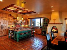 a large kitchen with an oven and dining room table