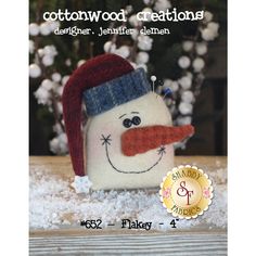 a small snowman with a red nose and blue hat