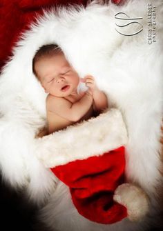 a baby is sleeping in a santa hat