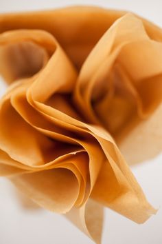 a close up view of the folds of a folded piece of paper on a white surface