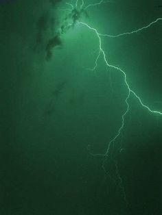 a green background with some lightning in the sky