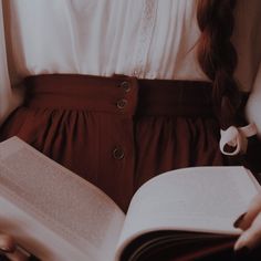 a woman holding an open book in her hands