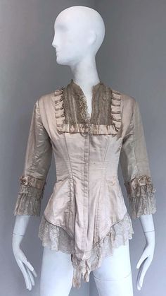 For Sale on 1stDibs - Incredible authentic Victorian Era (approximately 1880s) ivory silk lace corset bustier blouse! Features a fitted boned bodice with hook-and-eye closures Victorian Underbust Wedding Bodice, Victorian Overbust Wedding Bodice, Victorian Fitted Boned Bodice, Fitted Victorian Boned Bodice, Victorian Corset With Historical Design For Wedding, Victorian Wedding Corset With Historical Design, Fitted Victorian Dress With Boned Bodice, Victorian Corset With Historical Design For Formal Occasions, Victorian Wedding Dress With Underbust Style