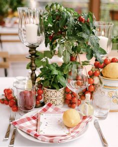 the table is set with fruit and candles