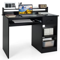 a computer desk with a monitor, keyboard and mouse on it in front of a white background