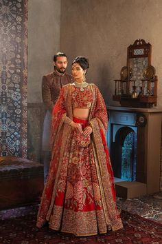 Pakistani Bridal Dress in Red Lehenga and Choli Style is an epitome of tradition and royalty. Floral designs, resham, naqshi, dabka, and crystals make this Lehenga Choli a breathtaking choice to wear on the big day for a flawless and royal bridal look. Royal Bridal Look, Choli Style, Bridal Lehenga Pakistani, Lace Designs On Suits, Pakistani Bridal Lehenga, Pakistani Lehenga, Red Lehenga Choli, Pakistani Bridal Dress, Pakistani Wedding Dress