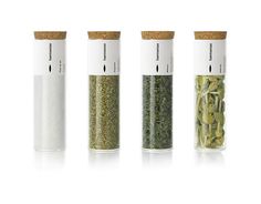 three different types of spices in glass bottles