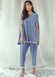 • Sky blue cotton silk handworked cape with resham and mirrorwork details on front and back • Paired with matching skinny shalwar with same work on bottom • Matching inner shirt (Includes Capr, inner shirt and skinny shalwar) Blue Cotton Silk Salwar Kameez With Mirror Work, Blue Cotton Silk Sets With Traditional Drape, Blue Cotton Silk Churidar With Dabka Work, Blue Straight Kurta With Mirror Work, Festive Cotton Pant Set With Mirror Work, Blue Lawn Suit With Mirror Work For Festivals, Blue Anarkali Lawn Suit With Mirror Work, Blue Cotton Traditional Wear With Mirror Work, Designer Blue Kurta With Mirror Work