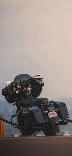 two motorcycles parked next to each other near the ocean