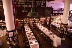 the dining room is set up with tables and bookshelves in front of them