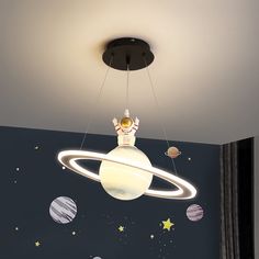 a child's room with planets, stars and a ceiling light