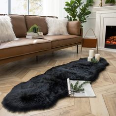 a living room filled with furniture and a fire place next to a couch in front of a fireplace