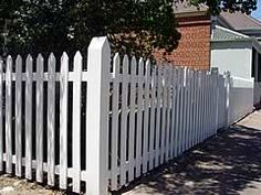 a white picket fence in front of a house