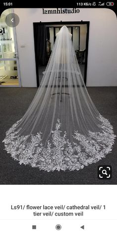 a white wedding veil with flowers on it