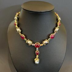 This is part of Chairish’s Fine Jewelry assortment.  Natural Red Ruby 54 Carats South Sea Oval shape Tahiti Pearls Natural Sapphires - 9 Carats 18K Yellow Gold  This Necklace is from the "Baroque" collection and it is the epitome of elegance and versatility and offers a perfect blend for day to night and swimwear to evening wear, allowing you to effortlessly transition between different occasions and outfits. Wearing this will undoubtedly make you the center of attention. It has a rich history g Pearl And Ruby Necklace, Luxury Ruby Necklace With Elegant Design, Luxury Red Jewelry For Ceremonial Occasions, Luxury Ceremonial Ruby Jewelry, Luxury Ruby Jewelry For Ceremonial Occasions, Ceremonial Luxury Ruby Jewelry, Luxury Red Necklace With Elegant Design, Luxury Red Necklaces With Elegant Design, Luxury Red Elegant Necklaces