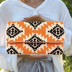 This Orange Beaded Bag is a must-have for every girl this season.  This stylish boho western clutch will make the perfect birthday gift and/or wedding gift.  Handcrafted and finished with a decorative magnetic clasp, and has an optional silver chain strap for use as a crossbody purse.   The size and shape of this clutch are the perfect accessories to carry everyday essential items. If you have any questions please feel free to reach out to us.    * Acrylic seed beads (cream, orange, and black se Bohemian Beaded Clutch For Everyday Use, Bohemian Beaded Pouch Clutch, Bohemian Beaded Festival Clutch, Summer Beaded Clutch As Gift, Bohemian Clutch As Summer Gift, Bohemian Handmade Clutch For Vacation, Bohemian Summer Clutch As Gift, Bohemian Clutch For Vacation, Summer Beach Beaded Clutch