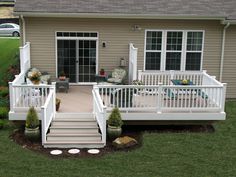 a white deck in front of a house