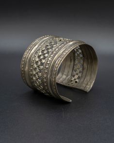 A beautiful relic from the past, this vintage silver cuff is crafted with passion by skilled artisans from the Turkman tribe, each design element tells a unique story waiting to be unraveled. This item will ship directly from Bali via DHL delivery. Please allow up to 15 business days to arrive. Handmade Vintage Jewelry In Antique Silver, Handmade Vintage Antique Silver Jewelry, Artisan Jewelry For Ceremonial Festivals, Handmade Bohemian Cuff Bracelet For Wedding, Handmade Artisan Metal Cuff Bracelet, Unique Oxidized Metal Cuff Bracelet, Unique Metal Cuff Bracelet With Oxidized Finish, Unique Silver Cuff Bracelet, Elegant Brass Cuff Bracelet With Antique Finish