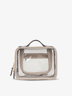 the clear bag is sitting on top of a white surface and has a black handle