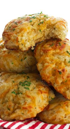 a pile of cheesy biscuits sitting on top of a red and white checkered napkin