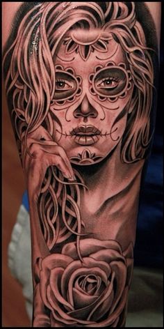 a woman's half sleeve with roses in her hand and a skull on it