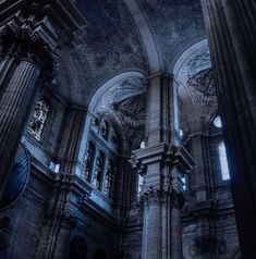 the interior of an old church with columns and stained glass windows