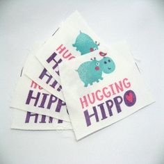 four napkins that say hugging hippo on them