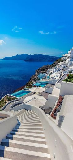 stairs leading down to the water and white buildings