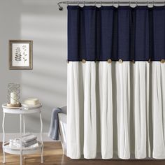 a bathroom with a blue and white shower curtain