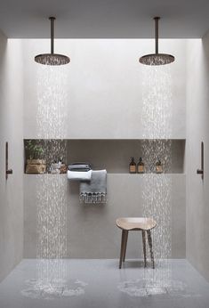 a shower head in the middle of a room with two lights hanging from it's ceiling