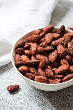 a white bowl filled with almonds on top of a table