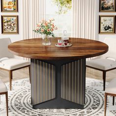 a round table with chairs around it in front of pictures on the wall and rug