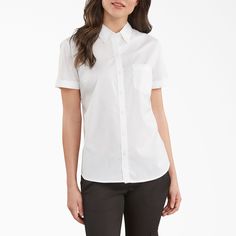 Button up your looks with Dickies' Women's Stretch Button-Up Shirt. It's a professional looking shirt with features that will keep you comfortable. The stretch poplin material and back pleat make it possible for you to move around how you need to, while the fabric still stays soft and durable. The bust darts provide you with a more fitted look that you'll feel confident wearing. The design also features a hi-lo hem that keep you covered so you can bend and stretch without becoming revealing. Dickies Clothing, Hand Stretch, Womens Work Shirt, Workwear Wardrobe, Dickies Shorts, Dickies Workwear, Dickies Women, Work Shirt, Lifestyle Clothing