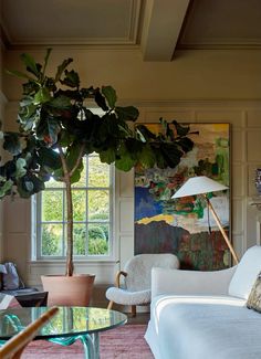 a living room filled with furniture and a potted plant